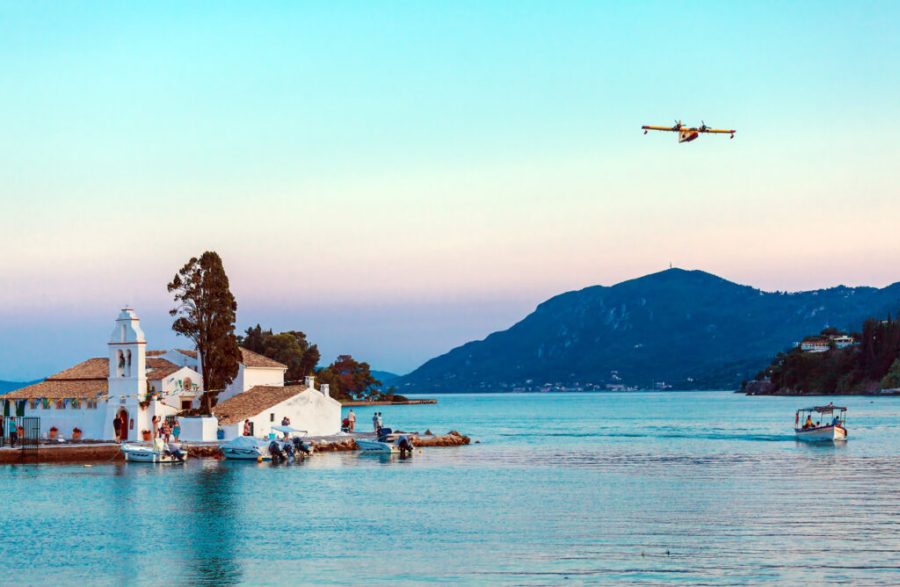 KANONI, GREECE JUNE 30, 2011: Sunset scene of Vlacherna with airplane above